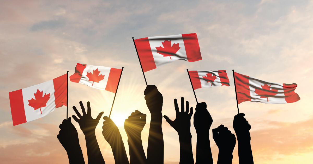 people waving Canada flags